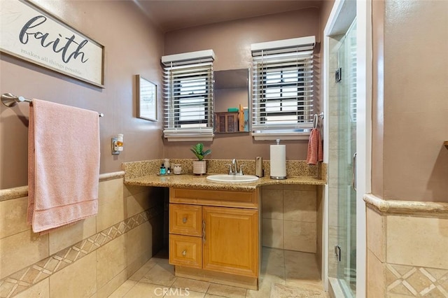 2118 W 84th St, Los Angeles, CA 90047 - bathroom featuring vanity, a shower stall, wainscoting, and tile patterned flooring