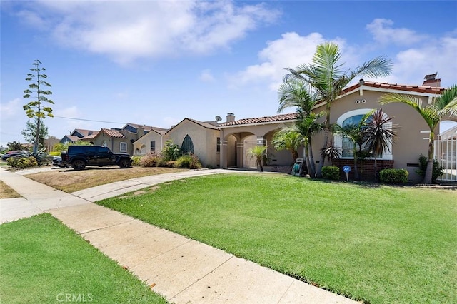 2118 W 84th St, Los Angeles, CA 90047 - mediterranean / spanish home featuring stucco siding, a front lawn, concrete driveway, and a chimney