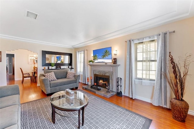 2118 W 84th St, Los Angeles, CA 90047 - living room featuring wood finished floors, a tiled fireplace, and ornamental molding