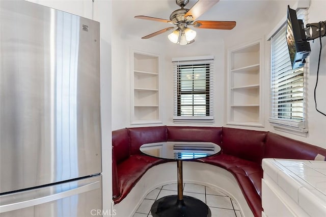 2118 W 84th St, Los Angeles, CA 90047 - tiled dining area featuring built in features and ceiling fan