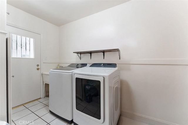 2118 W 84th St, Los Angeles, CA 90047 - washroom featuring washing machine and clothes dryer and light tile patterned flooring