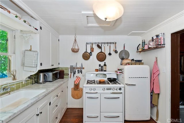 714 Blue Jay Canyon Rd, Lake Arrowhead, CA 92317 - kitchen with fridge, white cabinets, range with two ovens, light stone counters, and crown molding