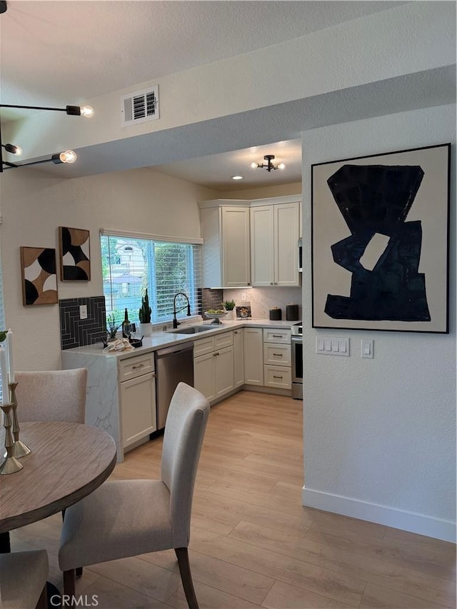 13 Silvertide Dr, Dana Point, CA 92629 - kitchen featuring stainless steel dishwasher, stove, light wood-type flooring, light countertops, and white cabinets