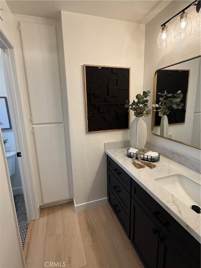 13 Silvertide Dr, Dana Point, CA 92629 - bathroom featuring wood finished floors, vanity, and a textured wall