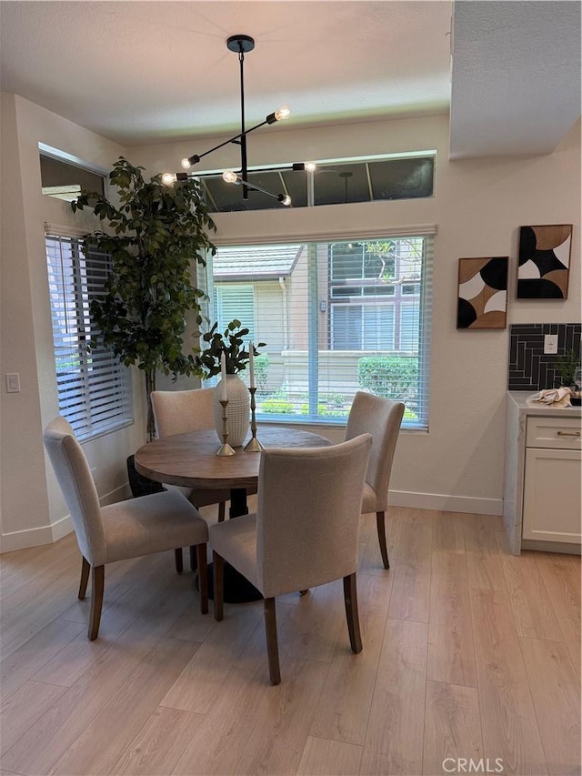 13 Silvertide Dr, Dana Point, CA 92629 - dining area featuring light wood-style flooring and a chandelier