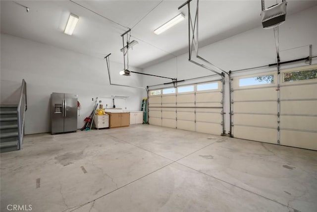 7105 Rayar Rd, Atascadero, CA 93422 - garage with stainless steel refrigerator with ice dispenser and a garage door opener