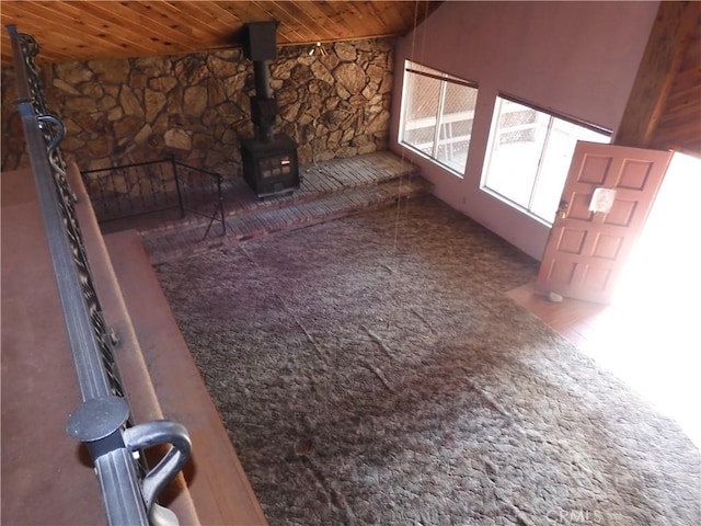 17216 Cedar Way, Clearlake Oaks, CA 95423 - unfurnished living room featuring wooden ceiling, carpet flooring, and a wood stove
