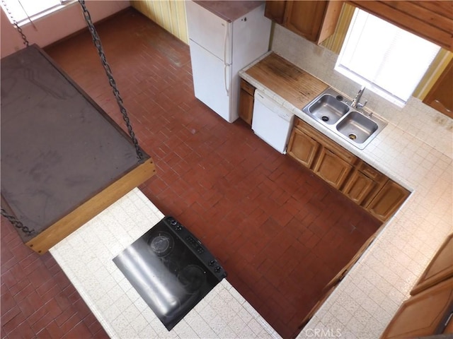 17216 Cedar Way, Clearlake Oaks, CA 95423 - kitchen with brick patterned flooring, white appliances, tile countertops, brown cabinetry, and decorative backsplash