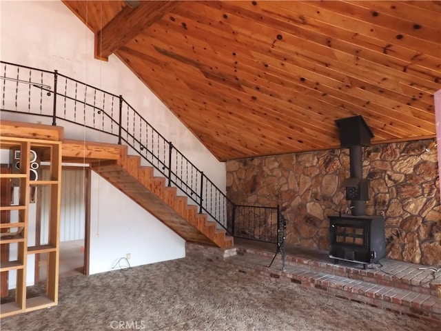 17216 Cedar Way, Clearlake Oaks, CA 95423 - unfurnished living room with carpet floors, wood ceiling, a wood stove, lofted ceiling, and stairway