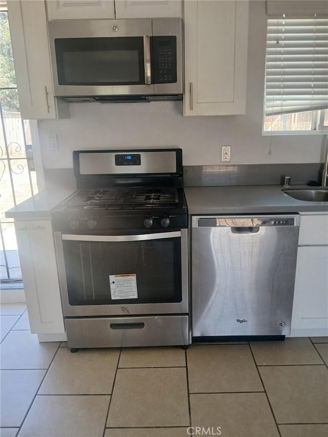 612 China Grade Loop, Bakersfield, CA 93308 - kitchen featuring stainless steel appliances, white cabinetry, and light tile patterned flooring