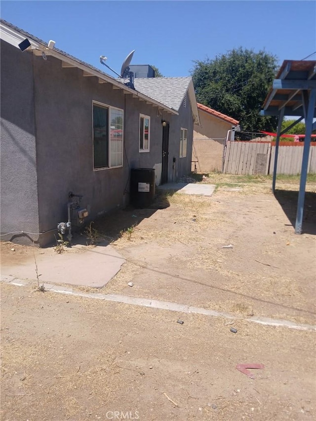 612 China Grade Loop, Bakersfield, CA 93308 - view of side of property featuring stucco siding and roof with shingles