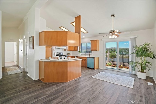 20128 Shadow Island Dr, Canyon Country, CA 91351 - kitchen featuring under cabinet range hood, dishwashing machine, light countertops, a ceiling fan, and dark wood-style floors