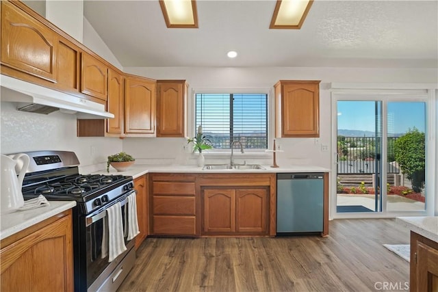 20128 Shadow Island Dr, Canyon Country, CA 91351 - kitchen featuring appliances with stainless steel finishes, under cabinet range hood, plenty of natural light, light countertops, and vaulted ceiling