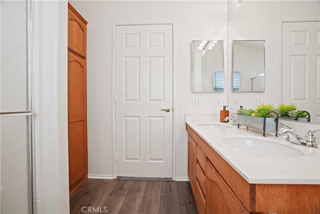 20128 Shadow Island Dr, Canyon Country, CA 91351 - bathroom featuring wood finished floors, double vanity, and an enclosed shower