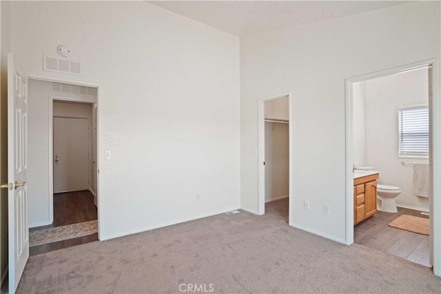 20128 Shadow Island Dr, Canyon Country, CA 91351 - unfurnished bedroom featuring carpet floors, a spacious closet, vaulted ceiling, and ensuite bath