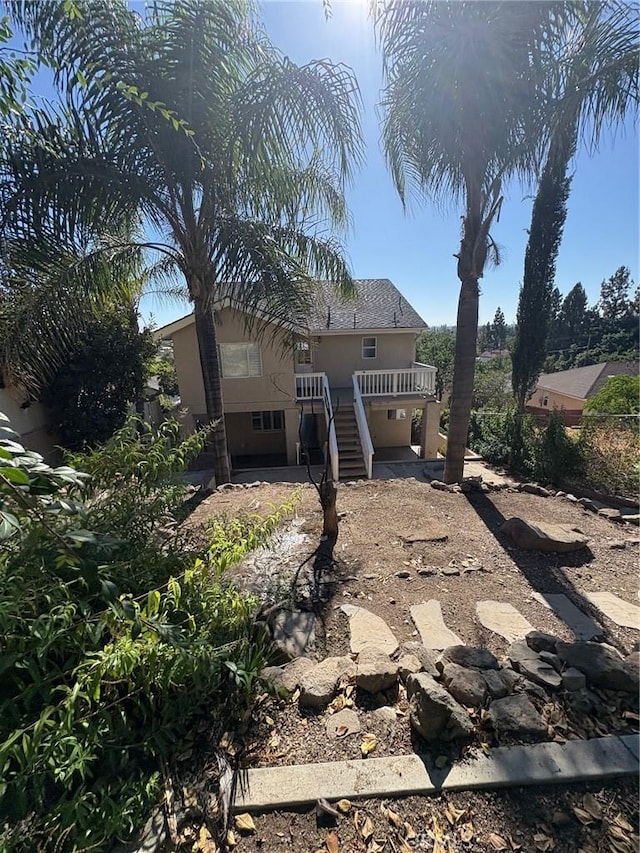 429 S Hill St, Orange, CA 92869 - back of house featuring stairs, stucco siding, and a wooden deck