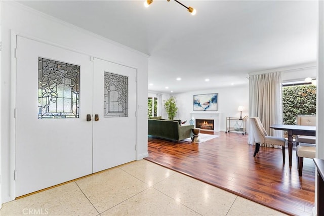 2117 N Westwood Ave, Santa Ana, CA 92706 - entrance foyer with plenty of natural light, a warm lit fireplace, recessed lighting, and crown molding