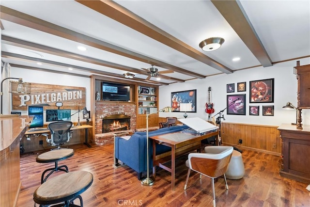 2117 N Westwood Ave, Santa Ana, CA 92706 - living area featuring beamed ceiling, ceiling fan, a brick fireplace, wood finished floors, and a wainscoted wall