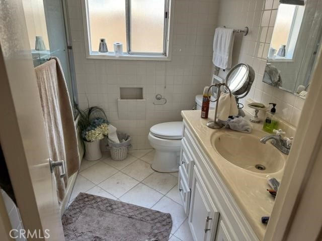 830 W Heber St, Glendora, CA 91741 - bathroom featuring tile patterned flooring, tile walls, vanity, and healthy amount of natural light