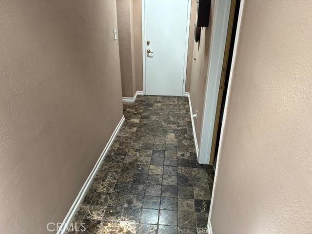830 W Heber St, Glendora, CA 91741 - corridor featuring baseboards and dark stone finish floors