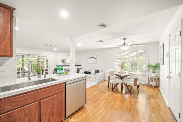 10601 Eton Ave, Chatsworth, CA 91311 - kitchen with dishwasher, recessed lighting, light countertops, brown cabinets, and healthy amount of natural light