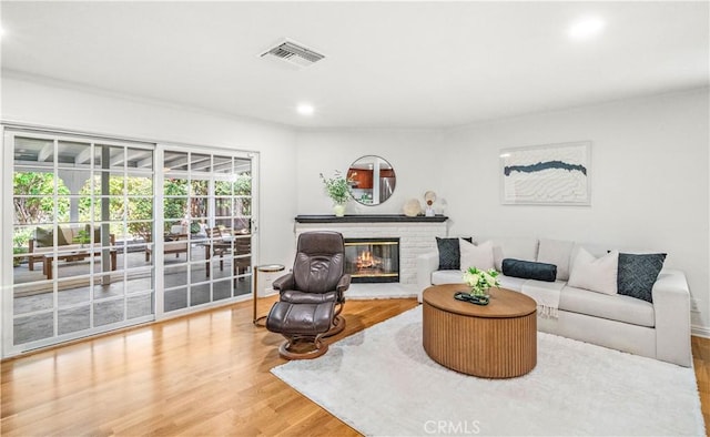 10601 Eton Ave, Chatsworth, CA 91311 - living area with wood finished floors, a brick fireplace, and recessed lighting