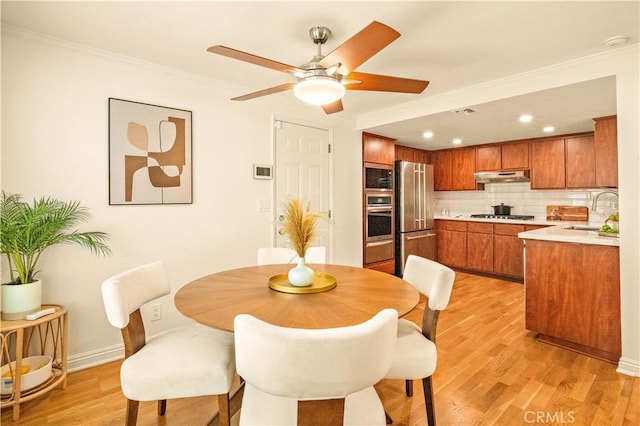10601 Eton Ave, Chatsworth, CA 91311 - dining space featuring light wood-style floors, ceiling fan, crown molding, and recessed lighting