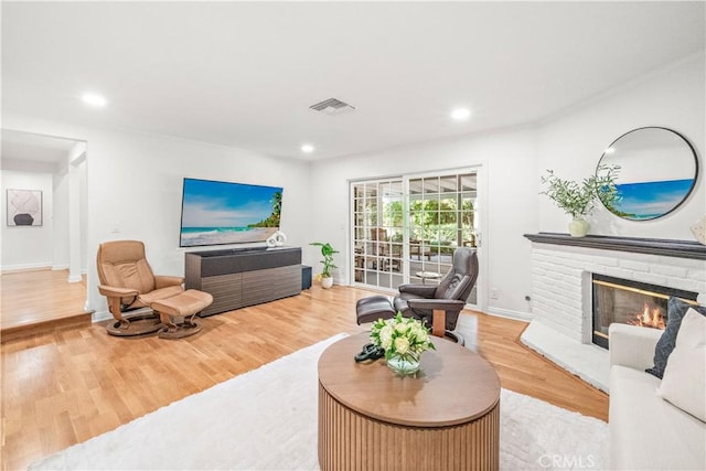 10601 Eton Ave, Chatsworth, CA 91311 - living room with wood finished floors, a fireplace, and recessed lighting