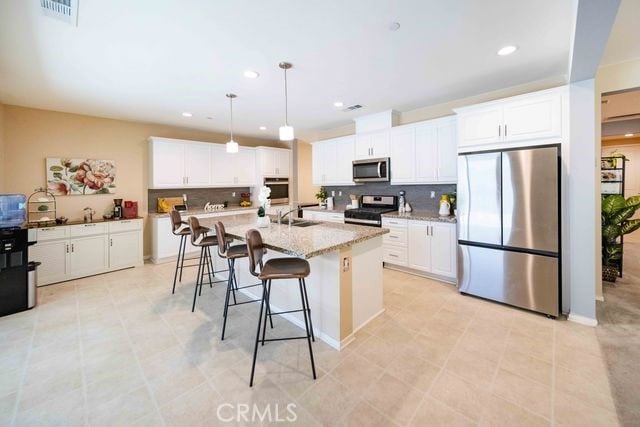 30106 Stargazer Way, Menifee, CA 92584 - kitchen with appliances with stainless steel finishes, backsplash, white cabinets, and recessed lighting