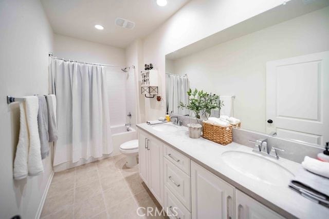 30106 Stargazer Way, Menifee, CA 92584 - bathroom with double vanity, shower / bath combo, tile patterned floors, and recessed lighting