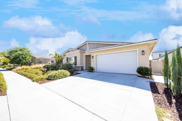 30106 Stargazer Way, Menifee, CA 92584 - view of front of house featuring an attached garage, driveway, stucco siding, and stone siding