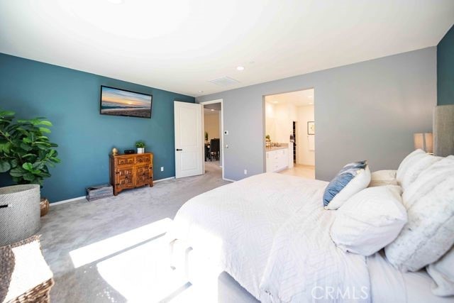 30106 Stargazer Way, Menifee, CA 92584 - bedroom featuring light colored carpet and connected bathroom