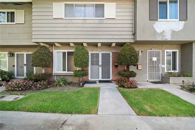 11903 Oertly Cir, Garden Grove, CA 92840 - property entrance featuring a lawn and brick siding