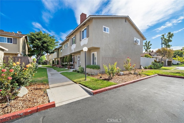 11903 Oertly Cir, Garden Grove, CA 92840 - view of side of home with a chimney, a residential view, and stucco siding