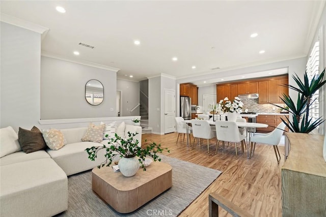 111 Thornhurst, Irvine, CA 92620 - living room with recessed lighting, ornamental molding, stairs, and light wood-style flooring