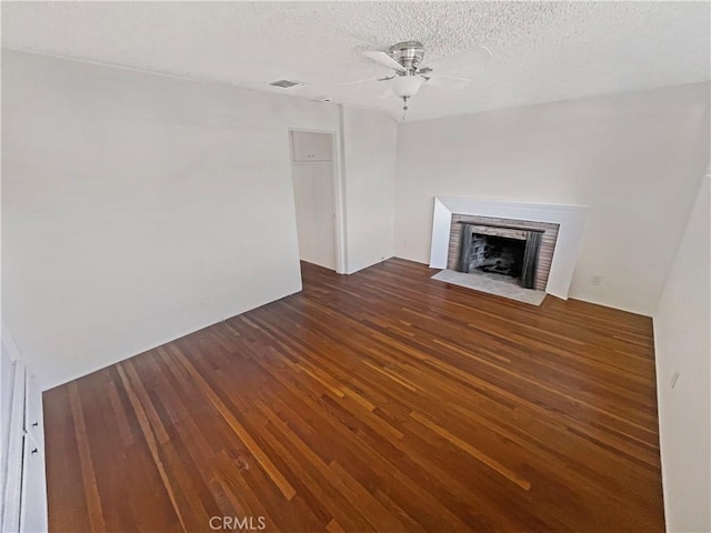 2334 N Keystone St, Burbank, CA 91504 - unfurnished living room with wood finished floors, a textured ceiling, a ceiling fan, and a brick fireplace