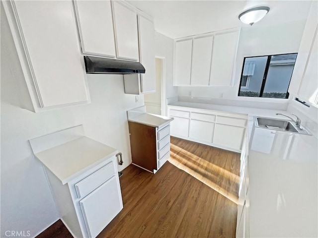 2334 N Keystone St, Burbank, CA 91504 - kitchen featuring dark wood-style flooring, white cabinetry, light countertops, and under cabinet range hood
