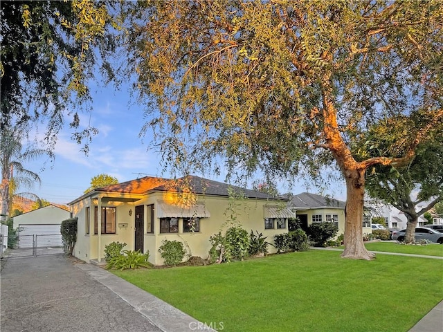 2334 N Keystone St, Burbank, CA 91504 - view of front facade featuring an outdoor structure, a front lawn, stucco siding, and a garage