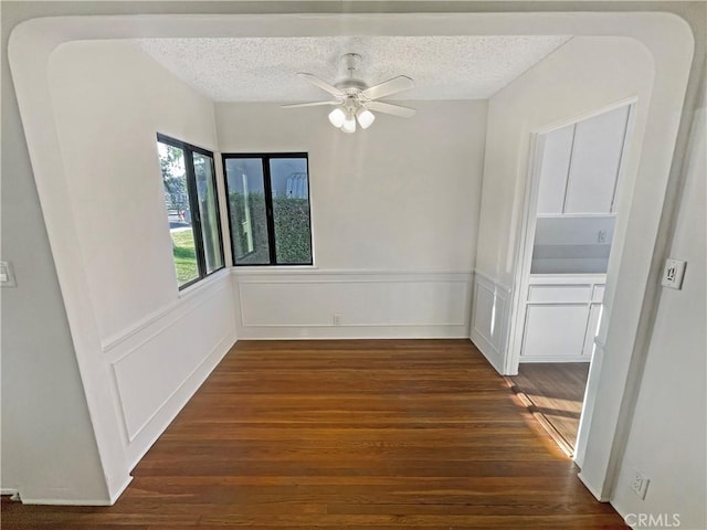 2334 N Keystone St, Burbank, CA 91504 - unfurnished room with wood finished floors, a ceiling fan, a textured ceiling, wainscoting, and a decorative wall
