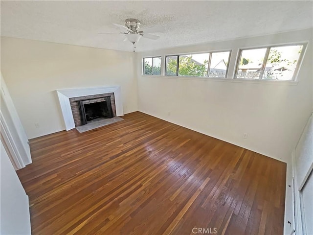 2334 N Keystone St, Burbank, CA 91504 - unfurnished living room featuring hardwood / wood-style floors, a brick fireplace, ceiling fan, and a textured ceiling