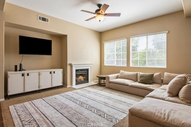 53085 Memorial St, Lake Elsinore, CA 92532 - living area featuring ceiling fan, light carpet, and a glass covered fireplace