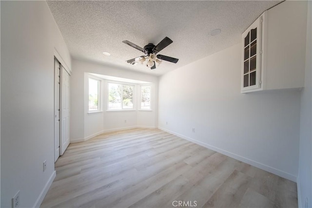 16520 Adelia St, Hesperia, CA 92345 - unfurnished bedroom featuring light wood-type flooring, a textured ceiling, a closet, and a ceiling fan