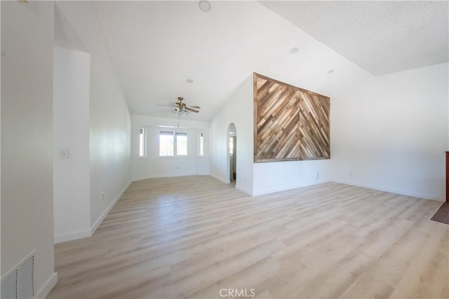 16520 Adelia St, Hesperia, CA 92345 - unfurnished living room featuring lofted ceiling, arched walkways, a ceiling fan, and light wood finished floors