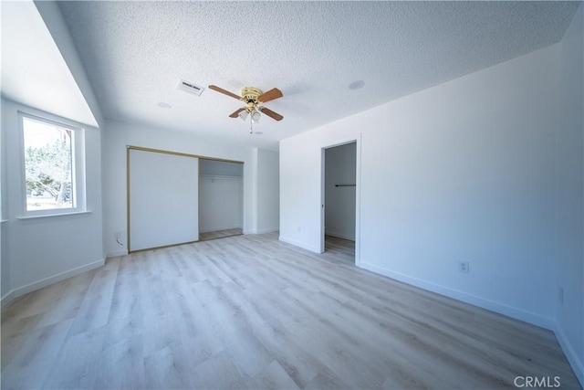 16520 Adelia St, Hesperia, CA 92345 - unfurnished bedroom with a textured ceiling, a closet, light wood-style flooring, and a ceiling fan