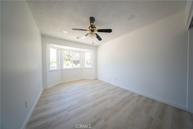 16520 Adelia St, Hesperia, CA 92345 - empty room with a textured ceiling, ceiling fan, and light wood-type flooring