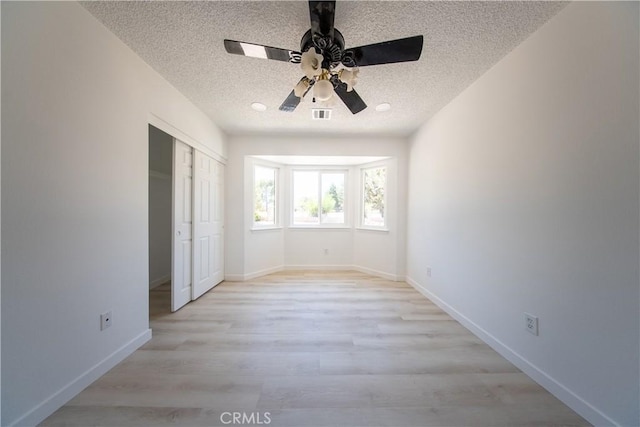16520 Adelia St, Hesperia, CA 92345 - unfurnished bedroom with a textured ceiling, light wood-style floors, a closet, and a ceiling fan