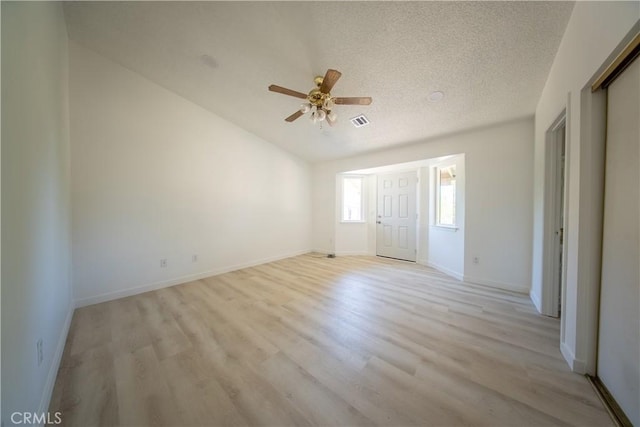 16520 Adelia St, Hesperia, CA 92345 - empty room with light wood-style flooring, a ceiling fan, a textured ceiling, and vaulted ceiling