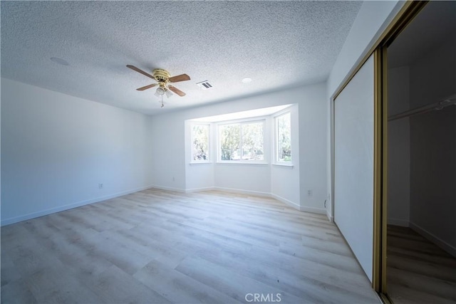16520 Adelia St, Hesperia, CA 92345 - unfurnished bedroom with a textured ceiling, light wood-type flooring, a closet, and ceiling fan