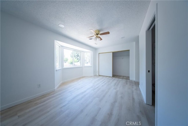 16520 Adelia St, Hesperia, CA 92345 - unfurnished bedroom featuring a textured ceiling, light wood-style flooring, a closet, and a ceiling fan