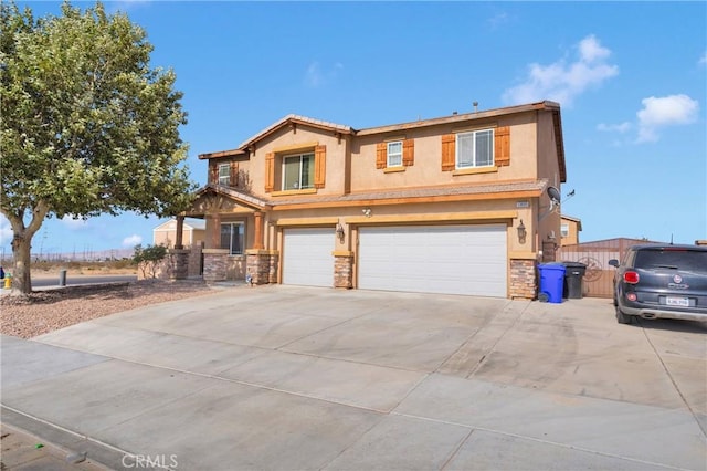13695 Mesa Linda Ave, Victorville, CA 92392 - view of front of home with stone siding, stucco siding, an attached garage, and driveway